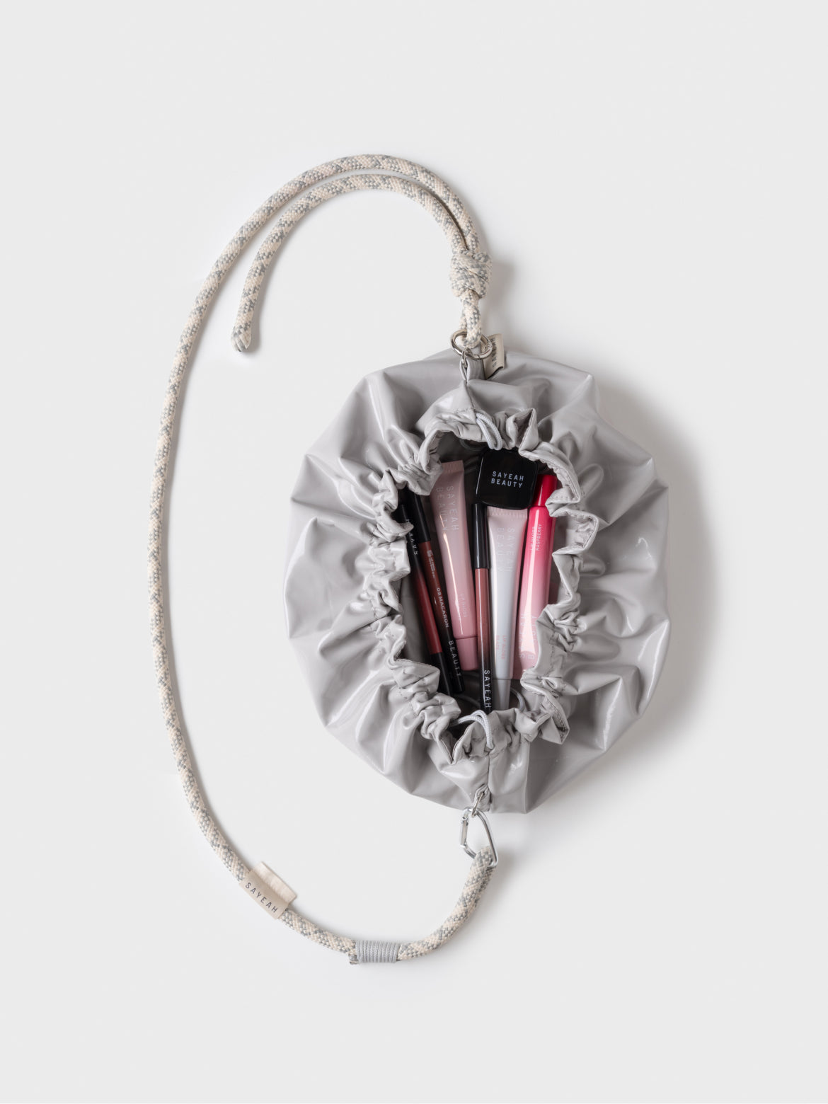 Сіра косметичка-сумка SELF-LOVE BAG GLOSSY GRAY у відкритому вигляді з косметикою